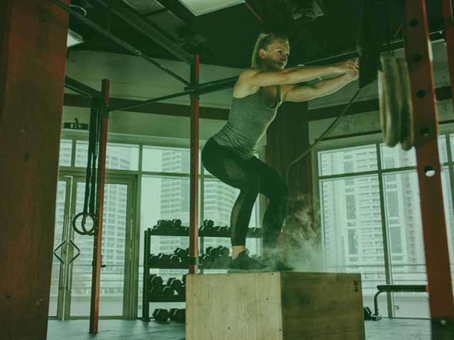 Photo of crossfit worker showing true grit during box jumps