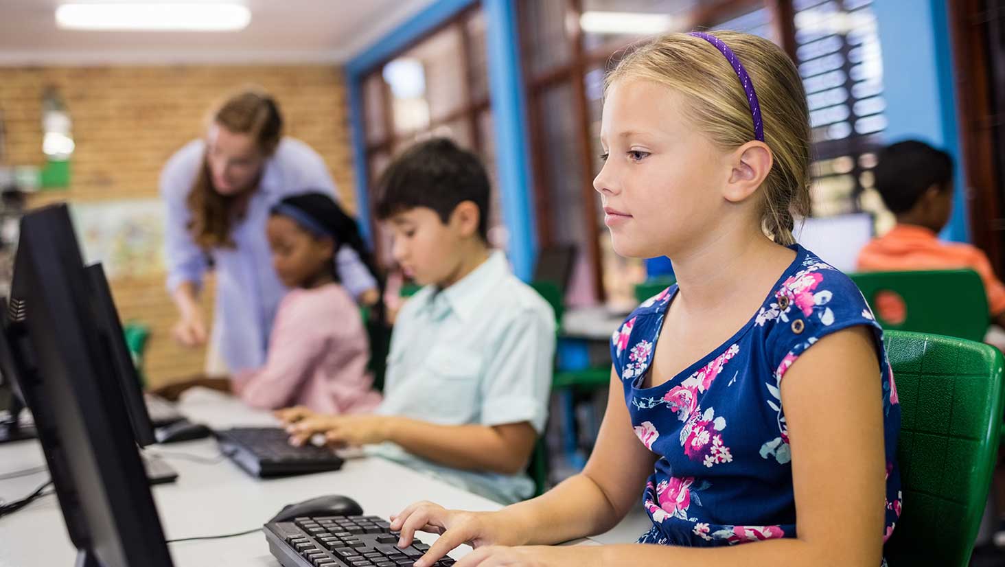 Photo of students on computers highlights importance of safeguarding student data