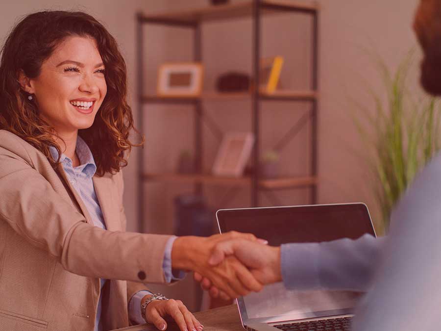 Photo of hiring officer shaking hands with a client