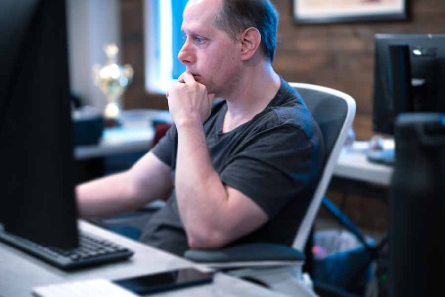 Front End Developer reviewing work on his computer